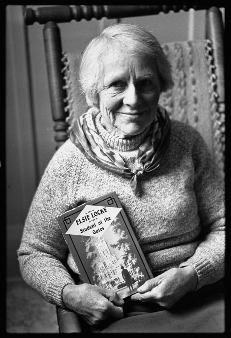 Elsie Locke. Portraits of Elsie Locke with a copy of her book "Student at the Gates", which is based on her experiences of being a student from Christchurch studying in Auckland. © Christchurch Star. <a href="https://canterburystories.nz/collections/archives/star/negatives/1981/ccl-cs-29384">CCL-Star-1981-4999-035-037N-01</a>